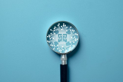 Lupe mit Gesetzsymbol auf türkis farbenem Hintergrund
