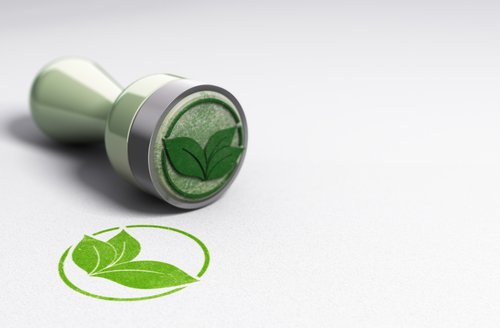 grüner stempel mit Blattmotiv als umweltfreundliche Kennzeichnung