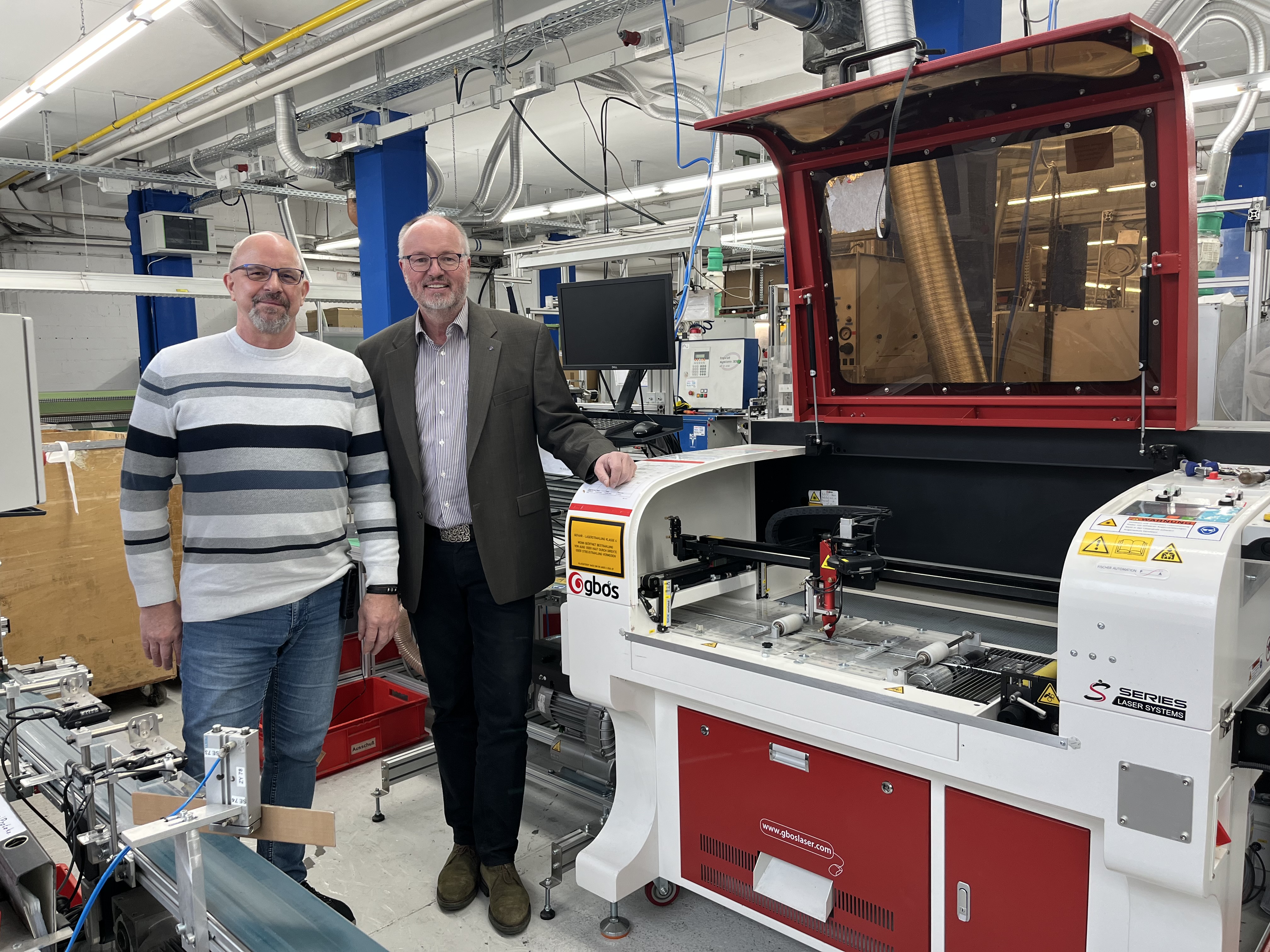 Betriebsleiter Peter Schulze und Geschäftsführer Andreas Oppermann vor der neu angeschafften hochmodernen Laserschneidanlage nebst KI-gestützter Qualitätsüberwachung.